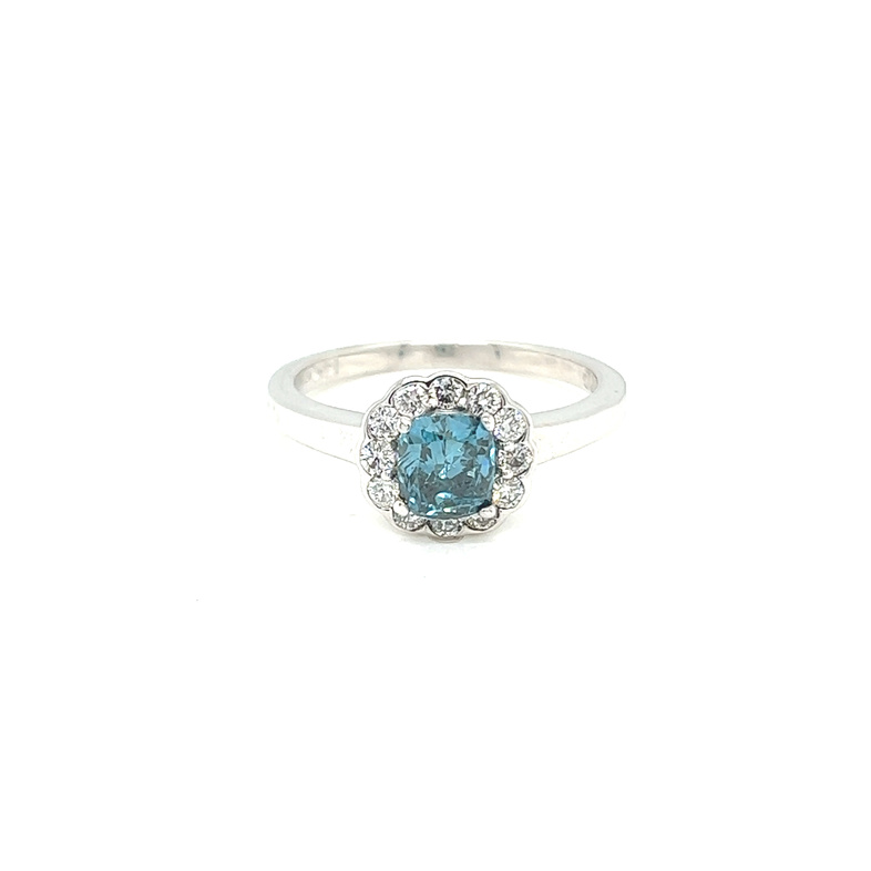 14 Karat white gold ring with one cushion cut blue irradiated Diamond that weighs .70carats and 12 round brilliant Diamonds with G color and SI clarity.  REF#130-805